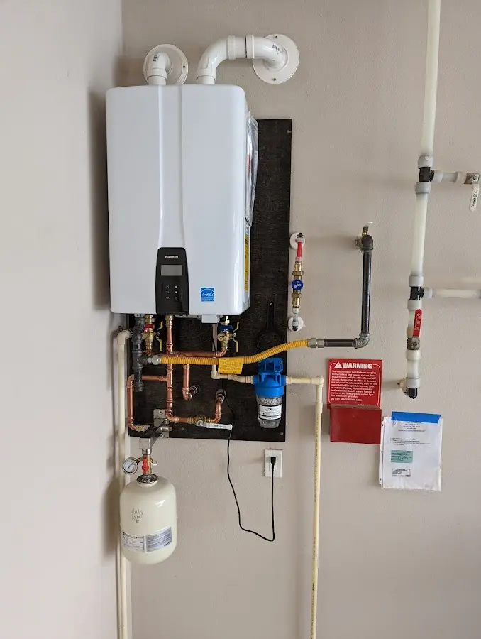 Professional plumber installing copper piping in a Carroll Valley home